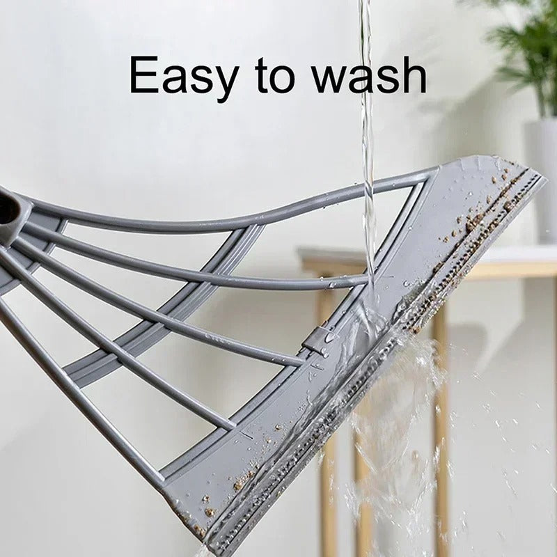 Close-up of the magic broom head being washed, demonstrating easy-to-clean silicone material.