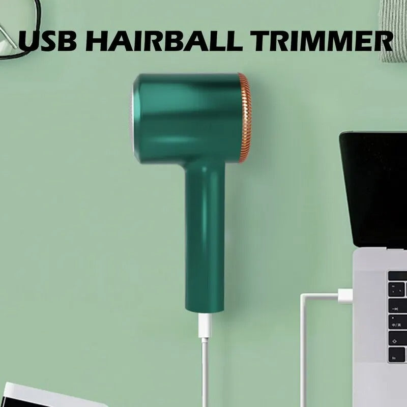 Green rechargeable fabric shaver connected to a laptop via USB cable for charging