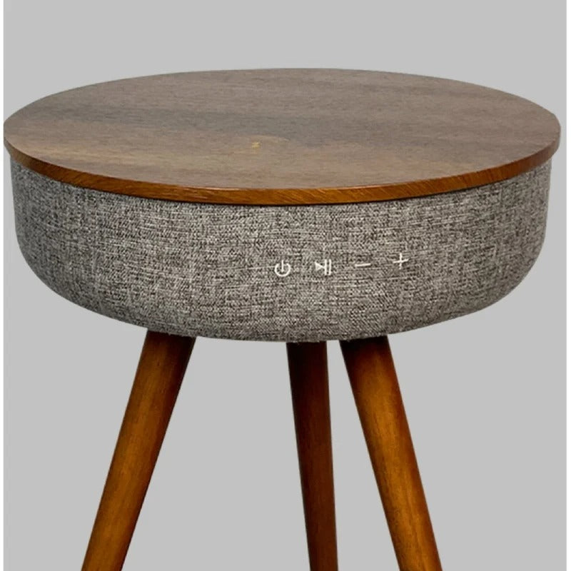 Close-up view of smart coffee table controls with fabric-wrapped speaker