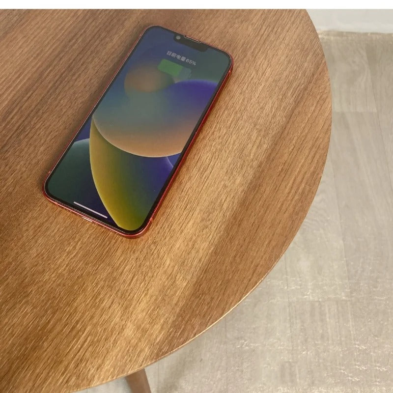 Smartphone charging on smart coffee table with built-in wireless charger