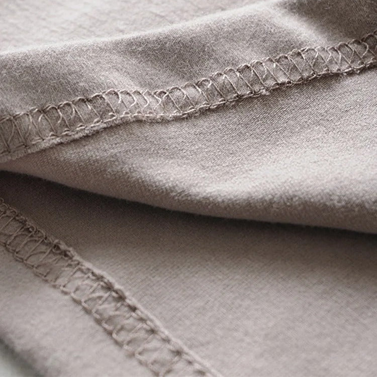 Close-up of the hem stitching on beige vintage biker punk crop top