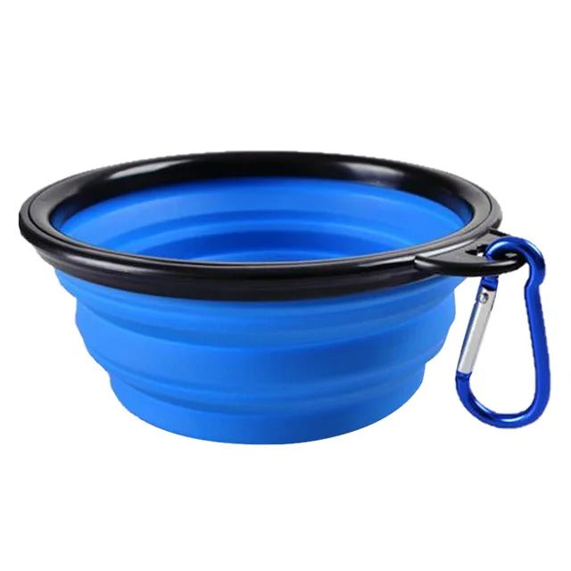 Collapsible pet food bowl in blue with carabiner clip, perfect for travel and outdoor adventures.