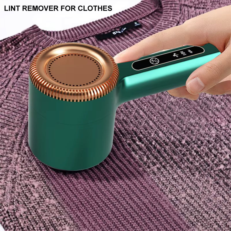 Hand using green fabric shaver to remove lint from a purple sweater