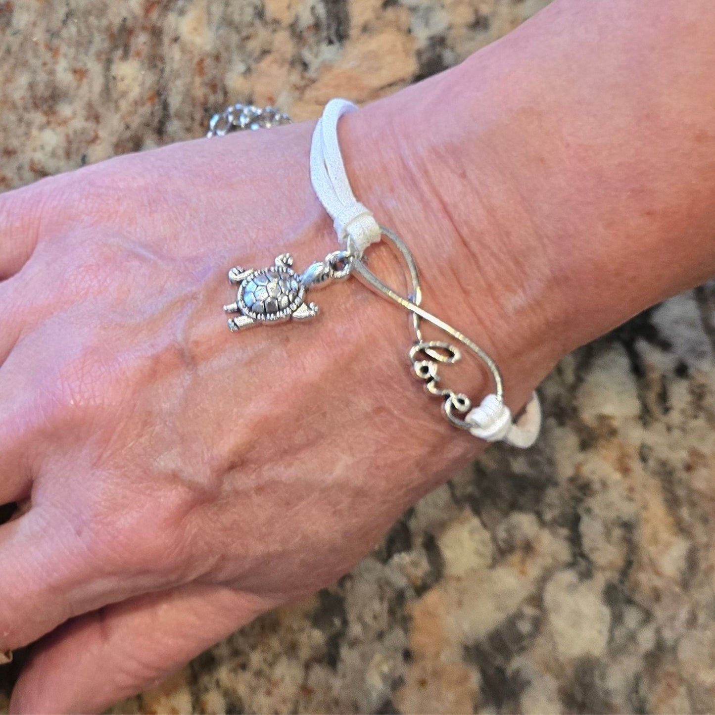 Infinite Love Turtle Bracelet worn on the wrist, showcasing its adjustable and stylish design.