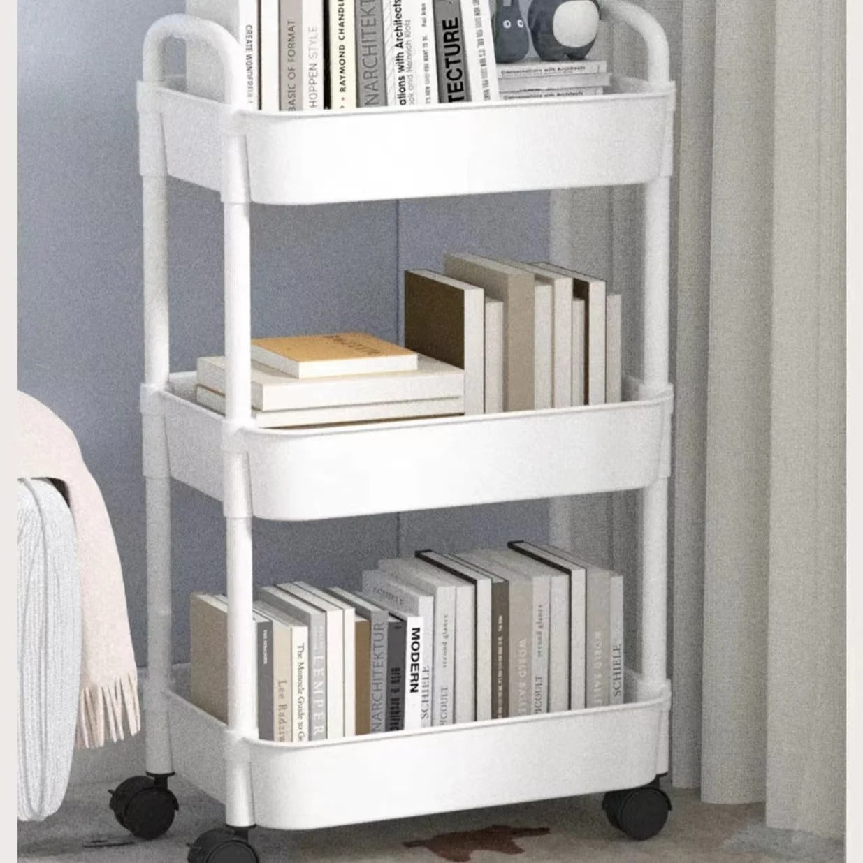 Minimalist white kitchen storage cart with wheels, perfect for home organization.