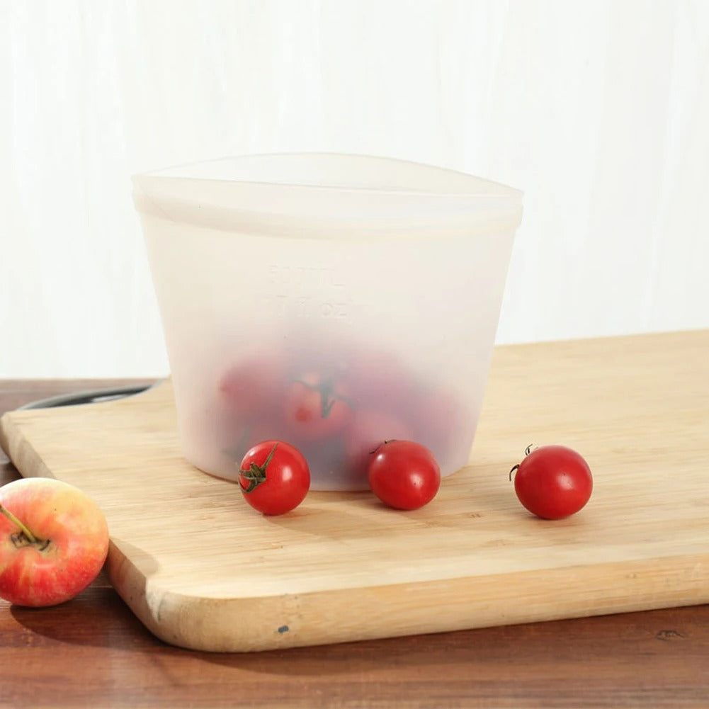 Transparent silicone food bag storing cherry tomatoes on cutting board