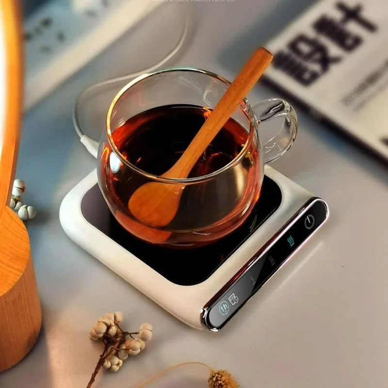USB mug warmer keeping a hot tea cup warm on a home or office desk.